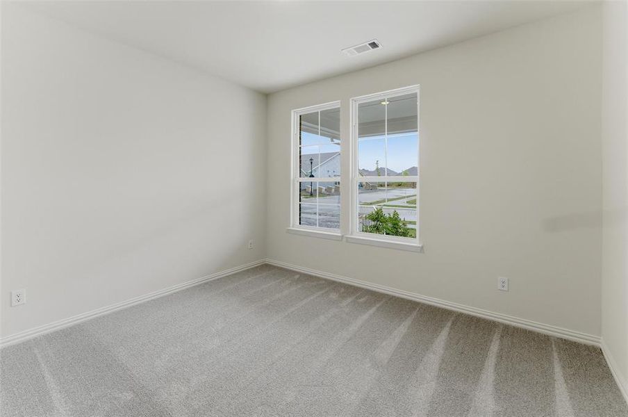 Neutral-toned walls complement the light gray carpet flooring