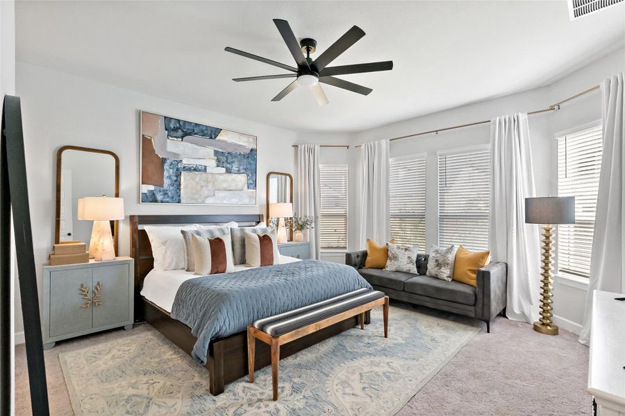Bedroom featuring a ceiling fan and carpet floors
