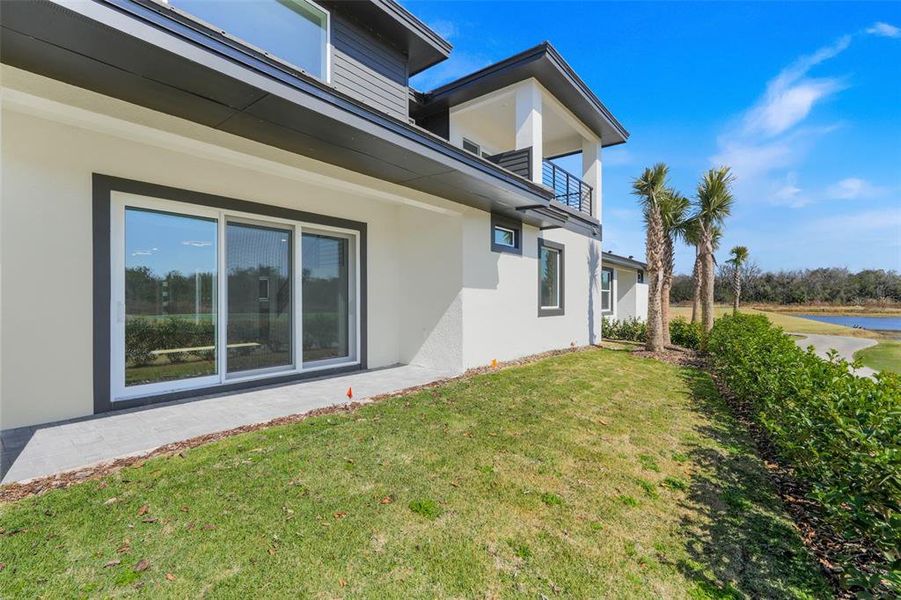 Exterior details and patio area of a home in Hampton Green at Providence, Davenport (Image 34).