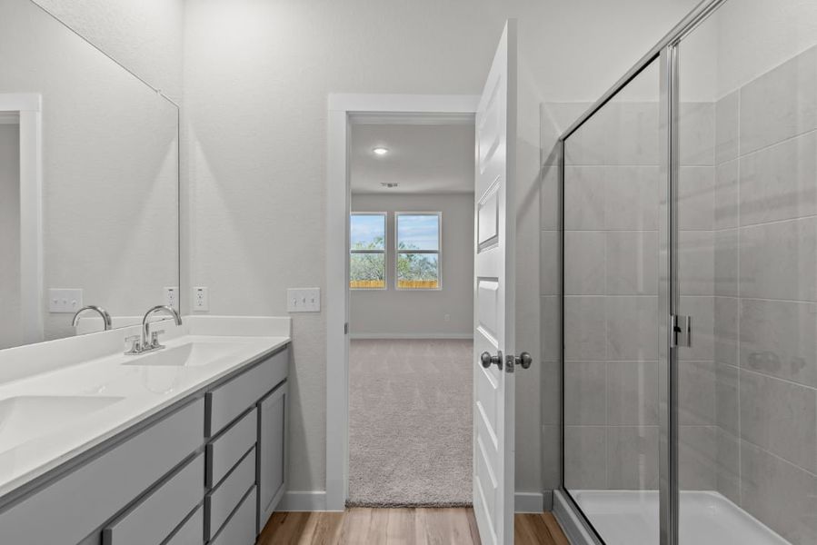 A bathroom with a glass shower. A bathroom with a glass shower.