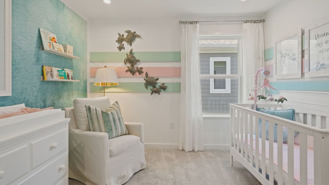 Carpeted secondary bedroom with large window in a DRB Homes Ambersweet model at the Trinity Place community. Carpeted secondary bedroom with large window in a DRB Homes Ambersweet model at the Trinity Place community.