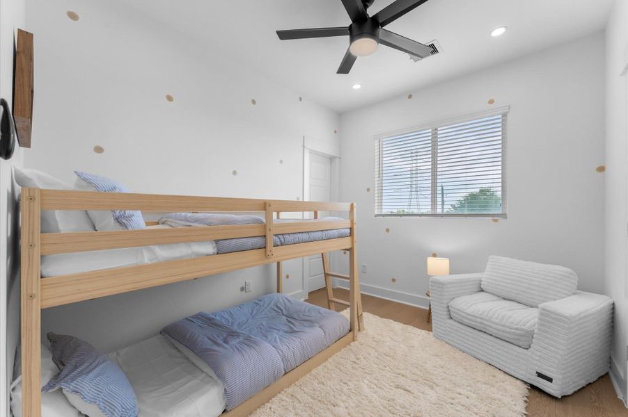 This second secondary bedroom, located near the primary suite, offers both comfort and convenience with its own private ensuite bathroom. The room is well-sized and versatile, ideal for use even as a play area. Large windows invite natural light, creating a bright and welcoming atmosphere, while the ensuite bathroom adds a touch of privacy and functionality. Its proximity to the primary bedroom makes it perfect for keeping loved ones close, while still providing independent space and comfort.