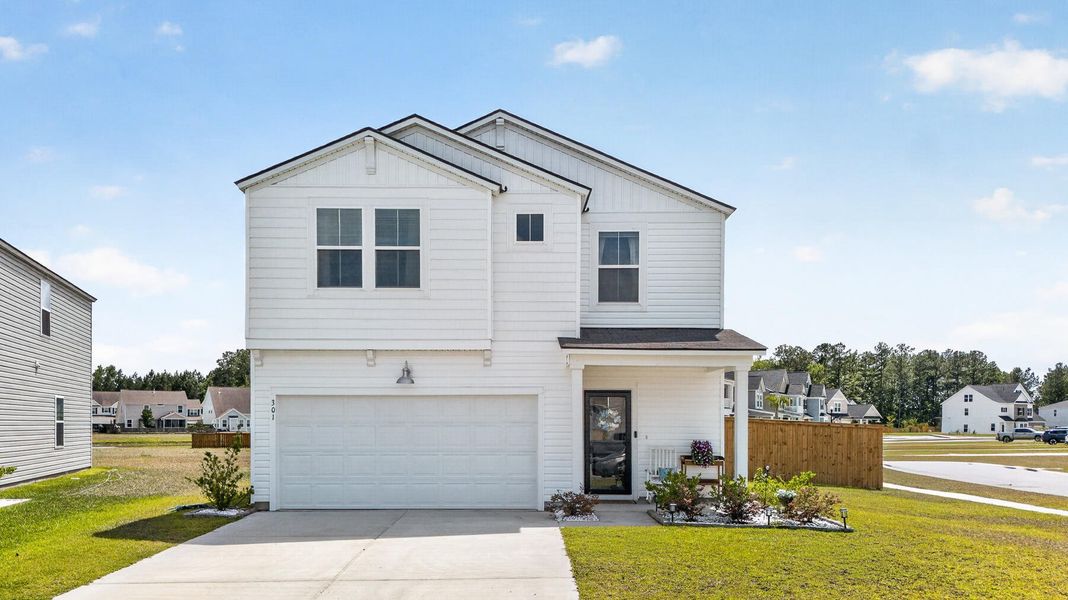 Front exterior of a new home in Lindera Preserve at Cane Bay Plantation, Summerville, SC, highlighting curb appeal (Image 23).