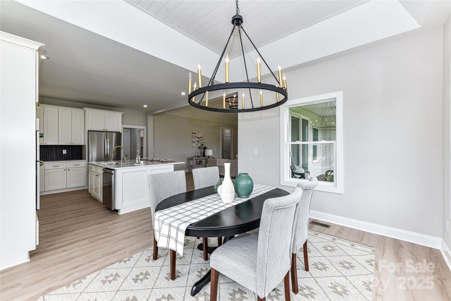 Beautiful Dining Area with tray, ship lap ceiling, custom light fixture & large windows for great natural light! Beautiful Dining Area with tray, ship lap ceiling, custom light fixture & large windows for great natural light!