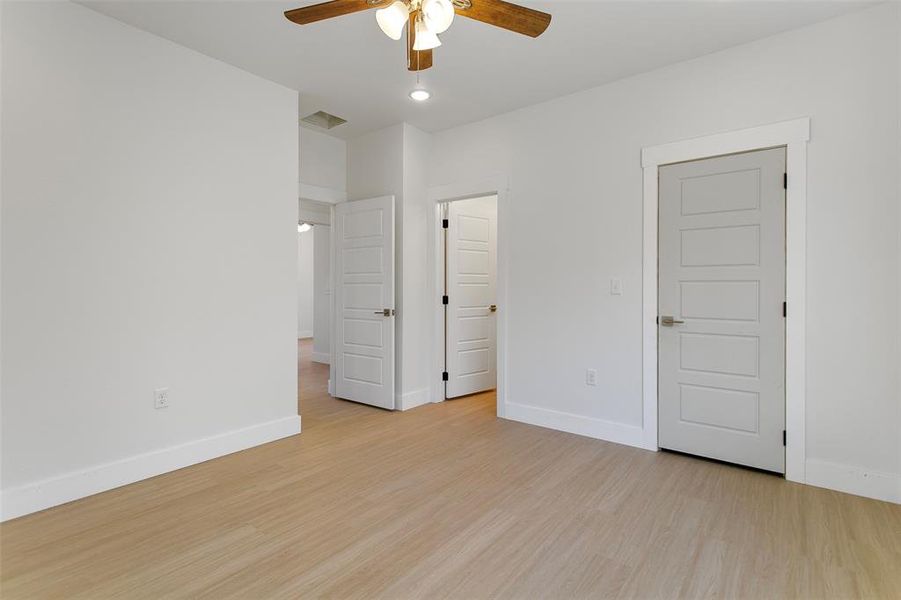 Unfurnished bedroom with ceiling fan and light hardwood / wood-style floors