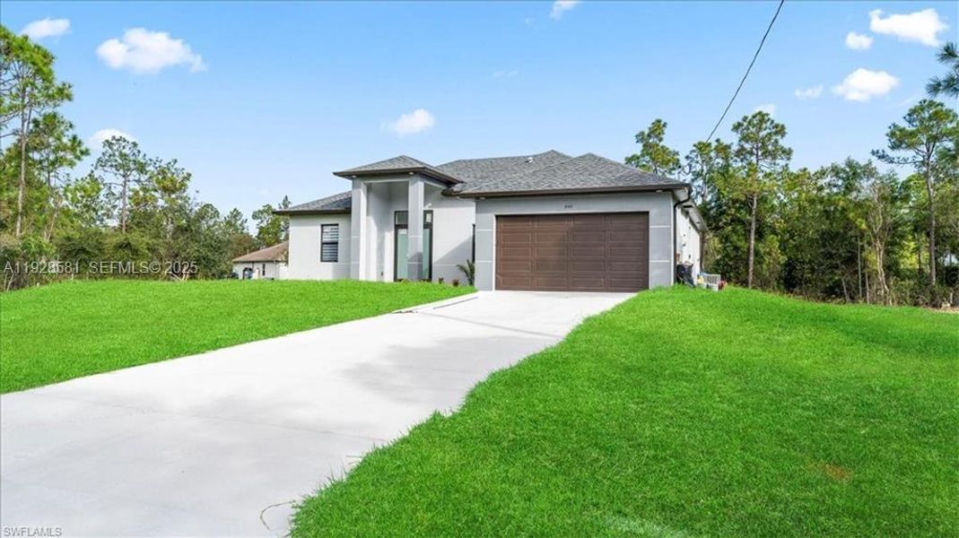 Front exterior of a new home in , Lehigh Acres, FL, highlighting curb appeal (Image 21).