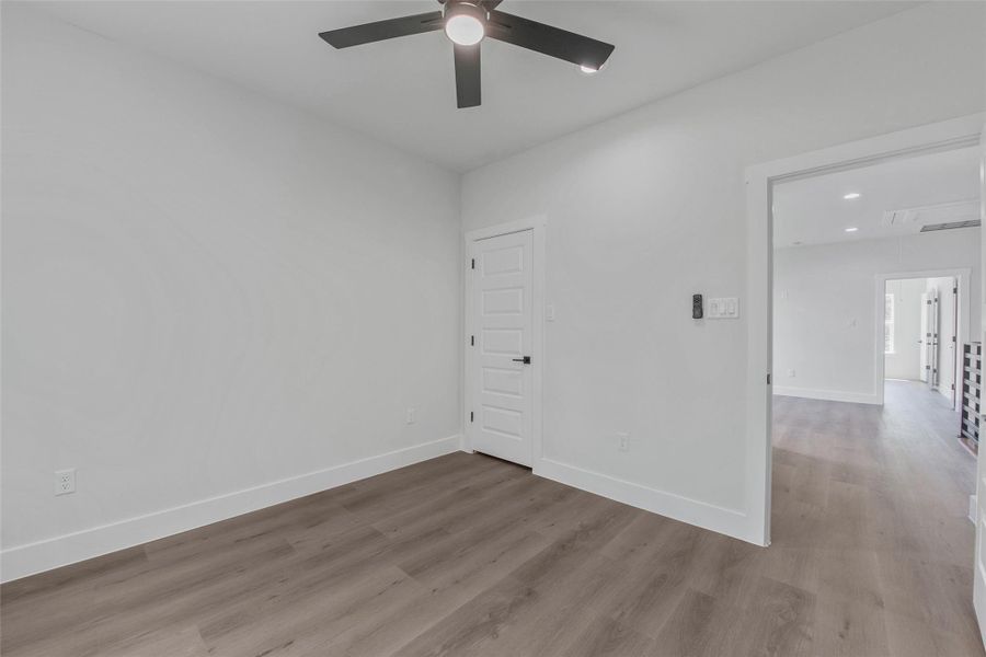 One of two secondary bedrooms, featuring a closet, no carpet, and a clean, modern finish. One of two secondary bedrooms, featuring a closet, no carpet, and a clean, modern finish.