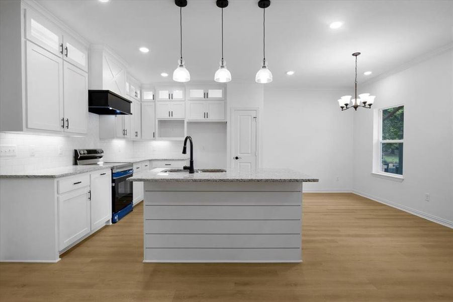 Kitchen featuring glass insert cabinets, range with electric cooktop, light stone countertops, white cabinetry, and recessed lighting