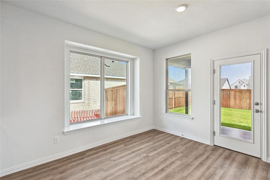 Empty room with hardwood / wood-style floors