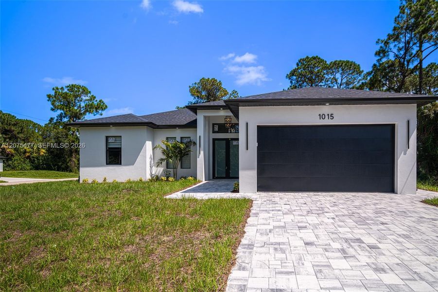 Front exterior of a new home in , Lehigh Acres, FL, highlighting curb appeal (Image 39). Front exterior of a new home in , Lehigh Acres, FL, highlighting curb appeal (Image 39).