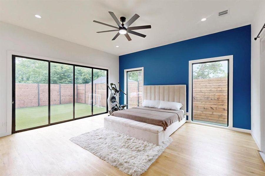 Bedroom featuring access to exterior, wood finished floors, recessed lighting, and ceiling fan Bedroom featuring access to exterior, wood finished floors, recessed lighting, and ceiling fan
