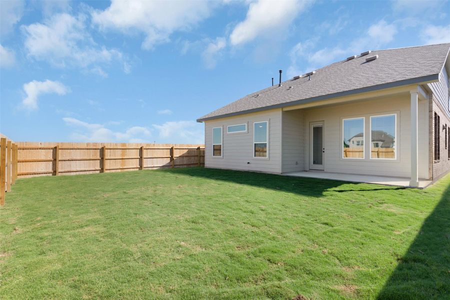 Rear view of property with a fenced backyard, a patio area, and a shingled roof