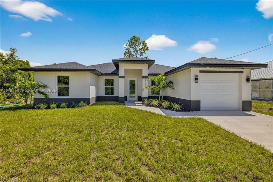 Front exterior of a new home in , Lehigh Acres, FL, highlighting curb appeal (Image 2). Front exterior of a new home in , Lehigh Acres, FL, highlighting curb appeal (Image 2).