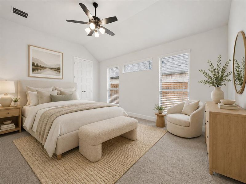 Primary bedroom featuring carpet flooring, multiple windows, a ceiling fan with integrated lighting