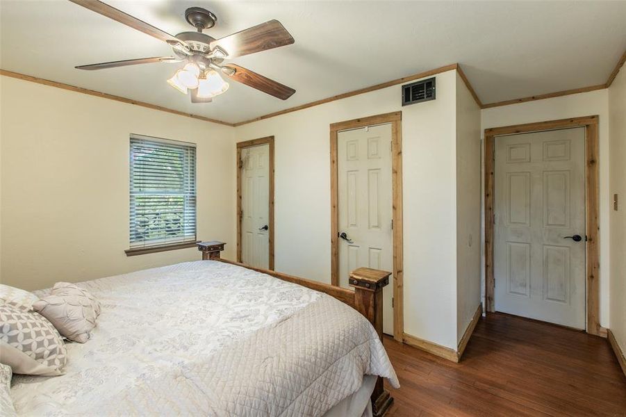 Primary bedroom offers hardwood floors, dual closets, and convenient access to the ensuite bath. Primary bedroom offers hardwood floors, dual closets, and convenient access to the ensuite bath.