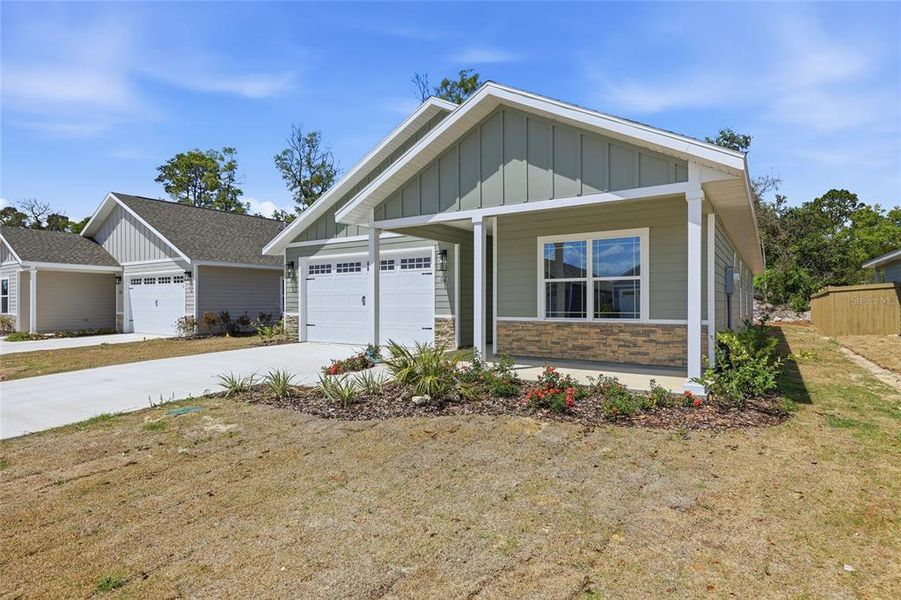 Front exterior of a new home in Grand Oaks, Gainesville, FL, highlighting curb appeal (Image 21).