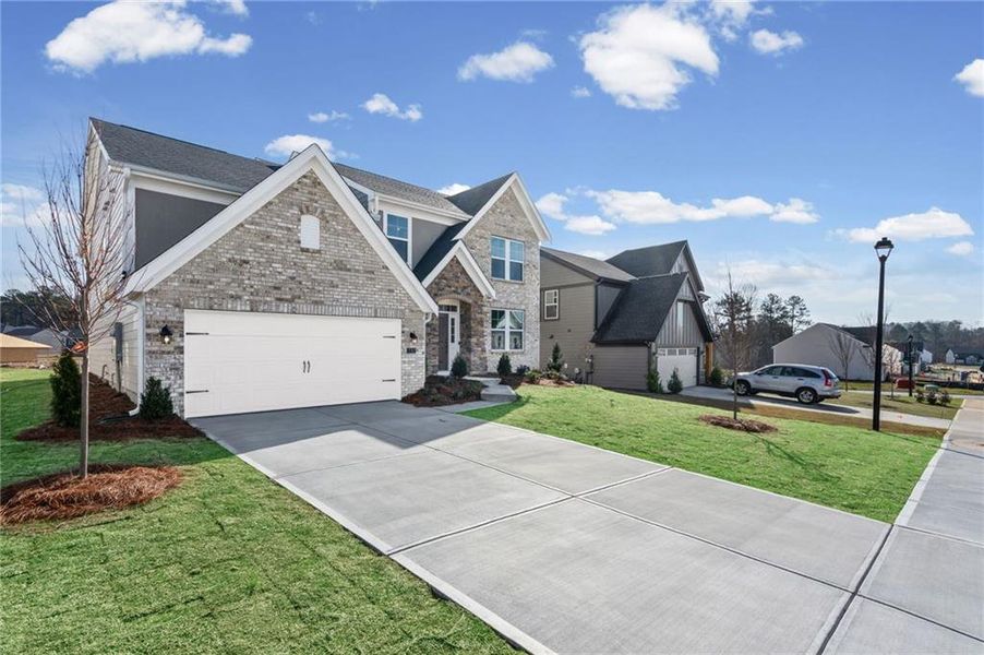 Front exterior of a new home in Twin Lakes, Hoschton, GA, highlighting curb appeal (Image 24). Front exterior of a new home in Twin Lakes, Hoschton, GA, highlighting curb appeal (Image 24).