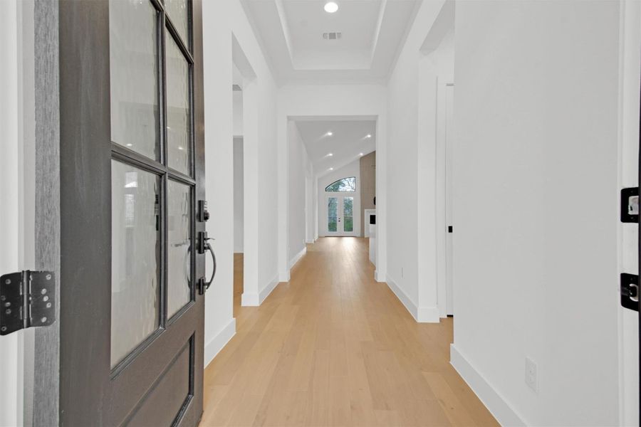 Home Entry featuring light hard wood floors, recessed lighting, and a raised 12ft tray ceiling