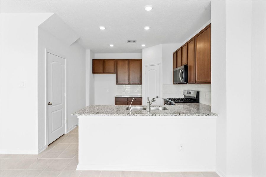 This spacious kitchen has it all—ample storage, generous counter space, and a layout that truly makes it the heart of the home. This spacious kitchen has it all—ample storage, generous counter space, and a layout that truly makes it the heart of the home.