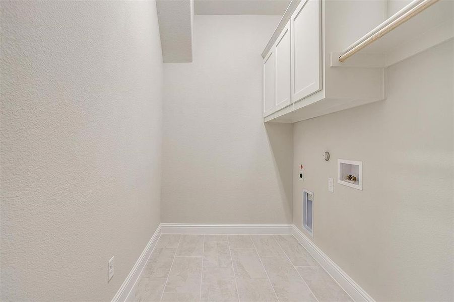 Laundry area with cabinets, washer hookup, hookup for a gas dryer, and electric dryer hookup