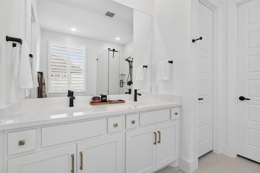 Hardware dresses up the cabinets. Dual sinks ensure domestic civility. Ditto for the separate water closet. Hardware dresses up the cabinets. Dual sinks ensure domestic civility. Ditto for the separate water closet.