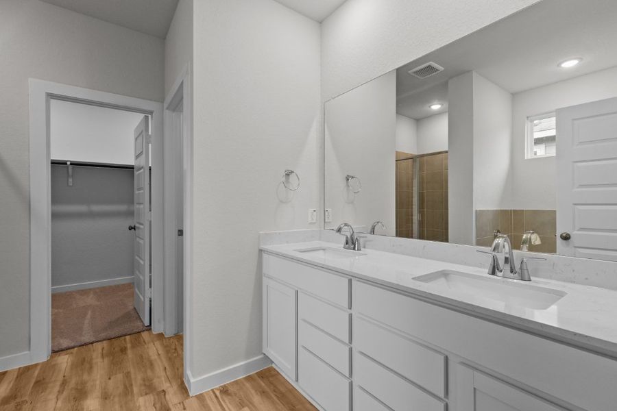 A bathroom with a large mirror. A bathroom with a large mirror.