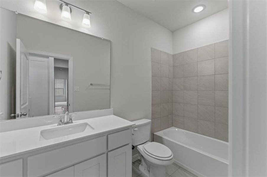 Full bathroom featuring a white vanity with an integrated sink, polished chrome faucet, and a large mirror