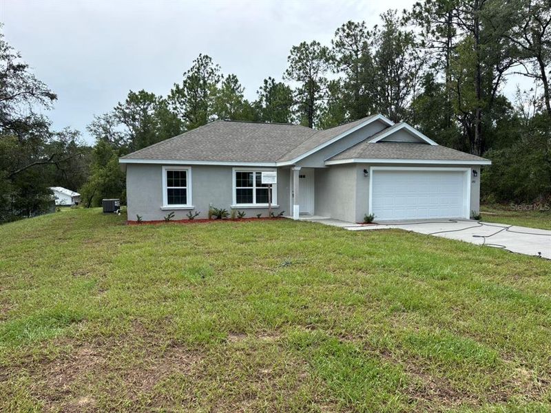 Front exterior of a new home in , Dunnellon, FL, highlighting curb appeal (Image 15).