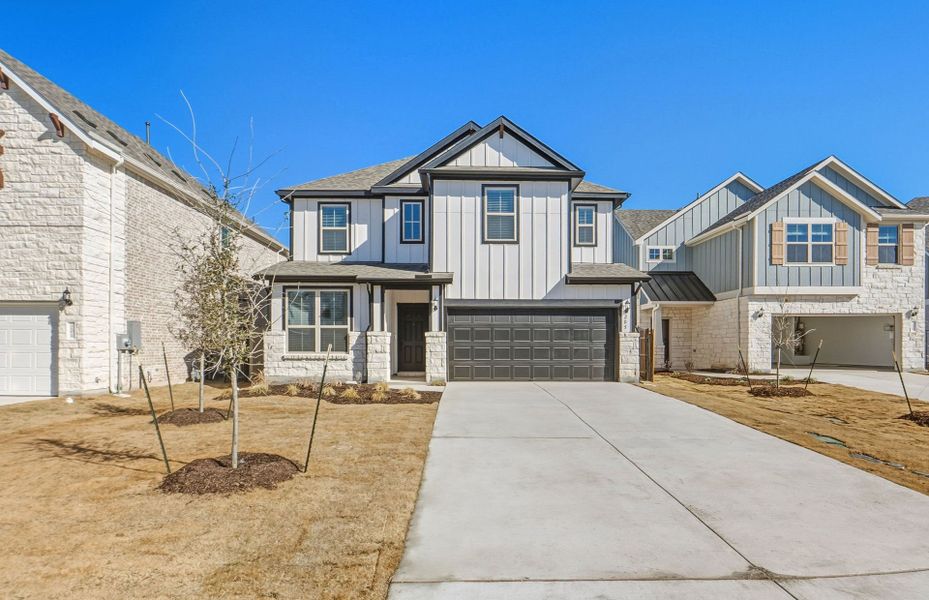 Front exterior of a new home in Santa Rita Ranch, Liberty Hill, TX, highlighting curb appeal (Image 22). Front exterior of a new home in Santa Rita Ranch, Liberty Hill, TX, highlighting curb appeal (Image 22).