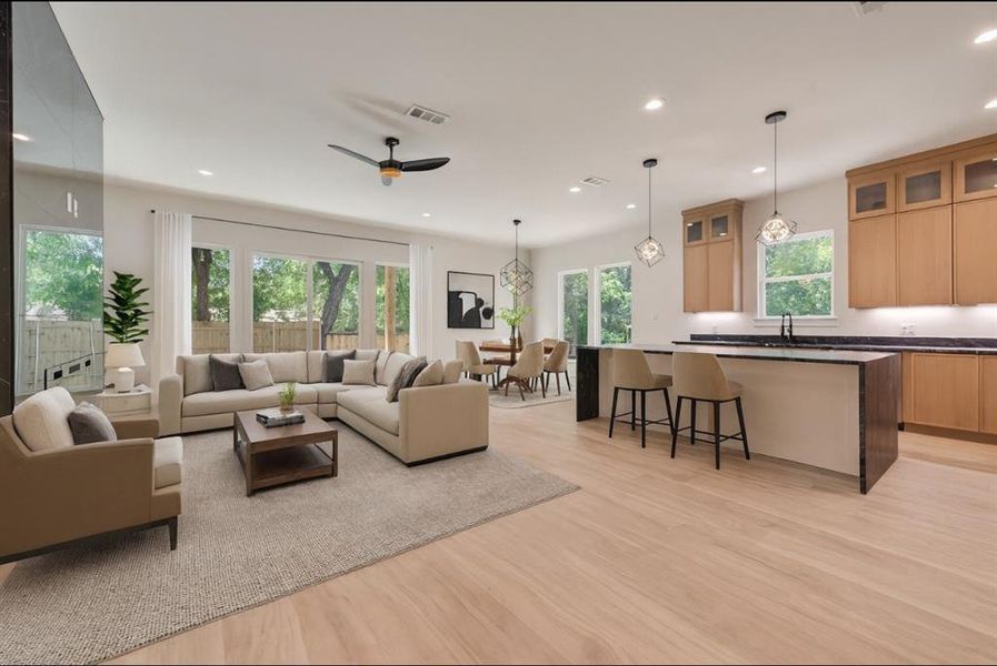 Living room featuring recessed lighting, light wood-style floors, healthy amount of natural light, and a ceiling fan