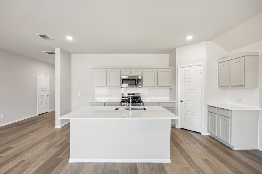 Kitchen in the Hadley  home plan by Trophy Signature Homes – REPRESENTATIVE PHOTO