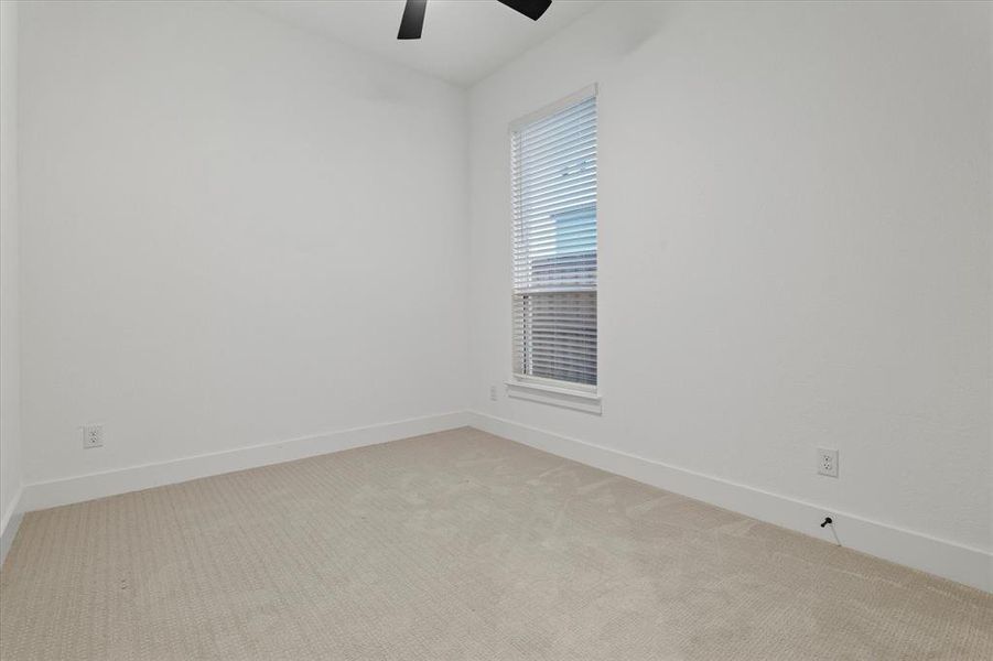 Spare room featuring carpet floors and a ceiling fan Spare room featuring carpet floors and a ceiling fan