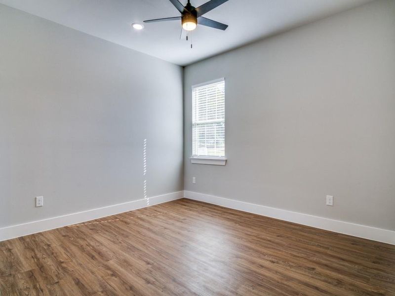 Unfurnished room featuring wood-type flooring and ceiling fan