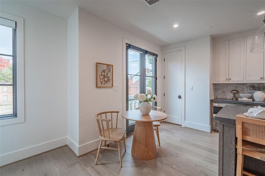 Dining space with light hardwood / wood-style floors