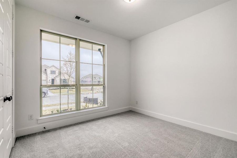 Unfurnished room featuring light colored carpet and a residential view