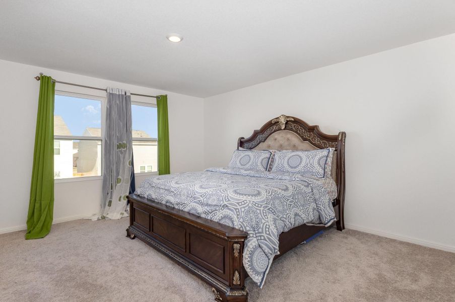 Bedroom with light colored carpet