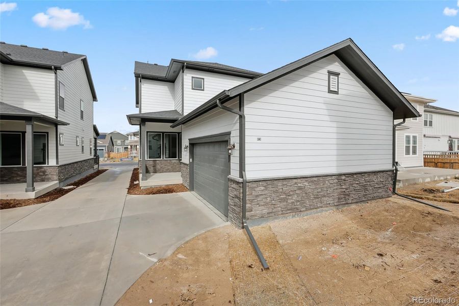 Exterior details and patio area of a home in Painted Prairie Cottage, Aurora (Image 4).