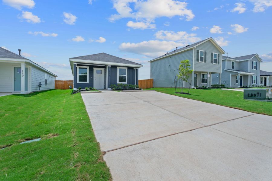 View of front of home featuring fence, concrete driveway, and a front yard View of front of home featuring fence, concrete driveway, and a front yard