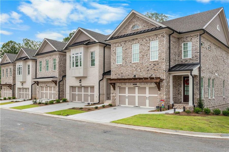 Front exterior of a new home in Ward's Crossing Townhomes, Johns Creek, GA, highlighting curb appeal (Image 2).
