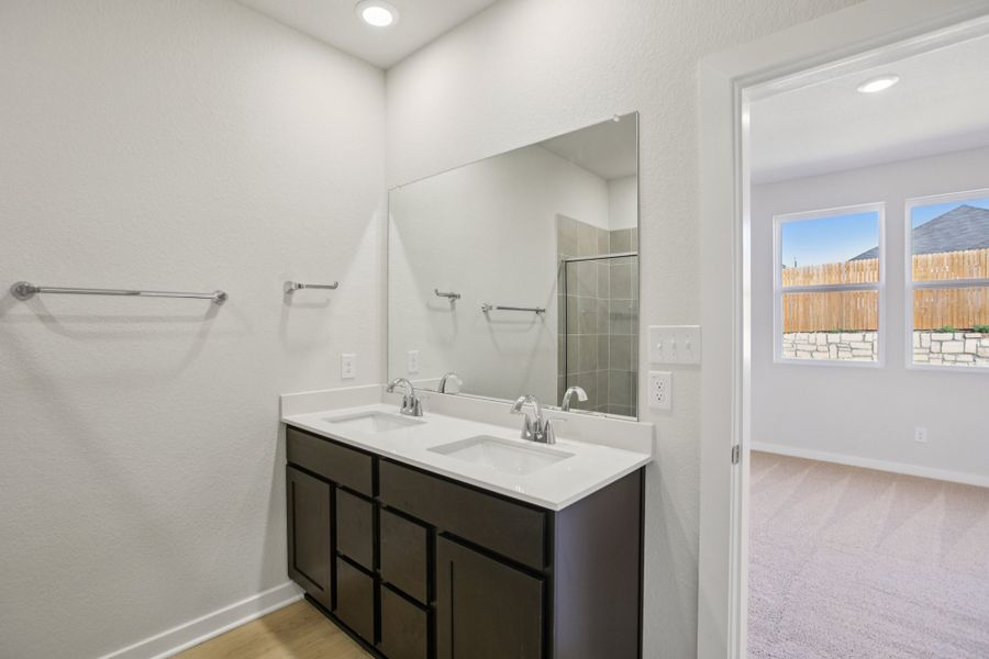 A bathroom with a large mirror.