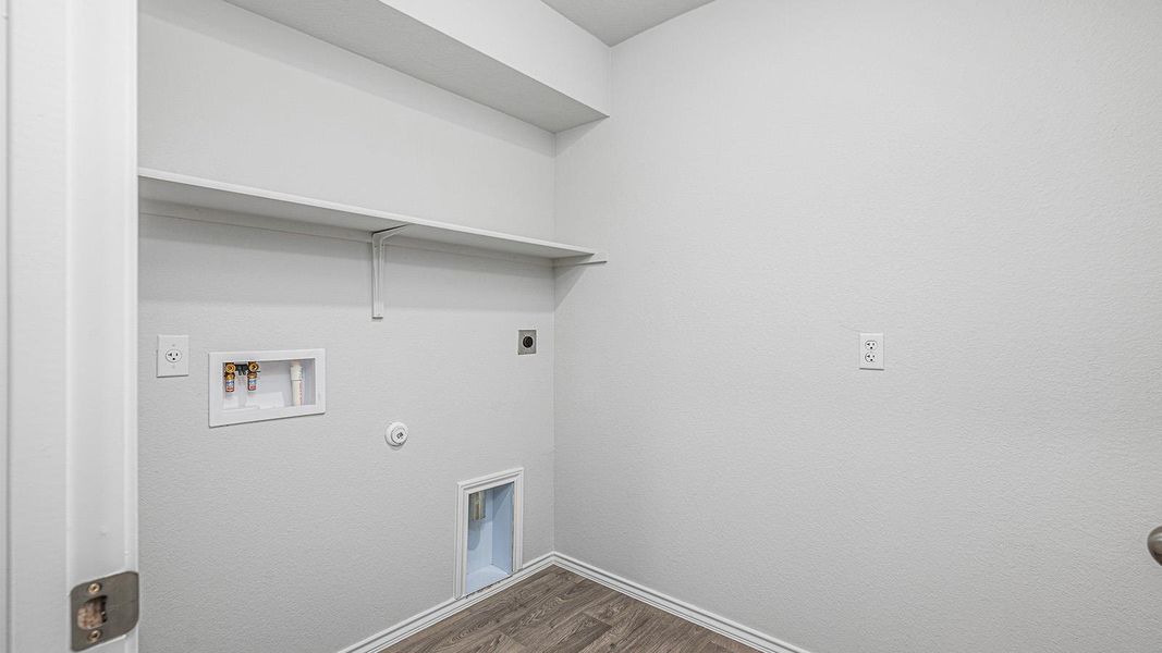 Laundry area with gas dryer hookup, dark wood-style flooring, washer hookup, and electric dryer hookup Laundry area with gas dryer hookup, dark wood-style flooring, washer hookup, and electric dryer hookup