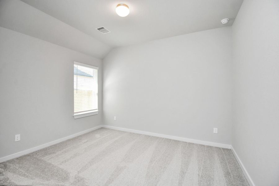 Secondary bedroom features plush carpeting, large windows that let in plenty of natural light, bright paint, and spacious closets. Sample photo of completed home with similar floor plan. Actual colors and selections may vary. Secondary bedroom features plush carpeting, large windows that let in plenty of natural light, bright paint, and spacious closets. Sample photo of completed home with similar floor plan. Actual colors and selections may vary.