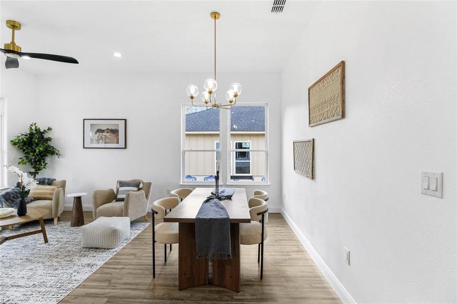 Dining area with light wood finished floors, a chandelier, a ceiling fan, and recessed lighting Dining area with light wood finished floors, a chandelier, a ceiling fan, and recessed lighting