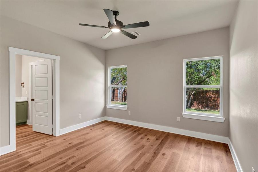Spare room featuring light wood-style floors and a ceiling fan Spare room featuring light wood-style floors and a ceiling fan