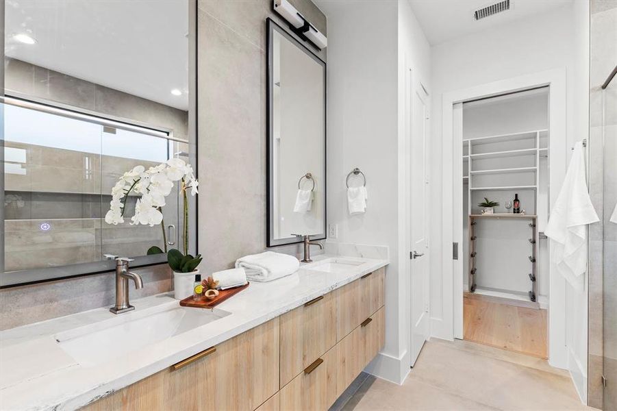 Bathroom featuring walk in shower and vanity