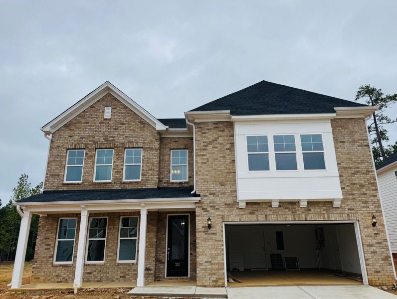 Front exterior of a new home in Pebble Branch, Chapin, SC, highlighting curb appeal (Image 1).