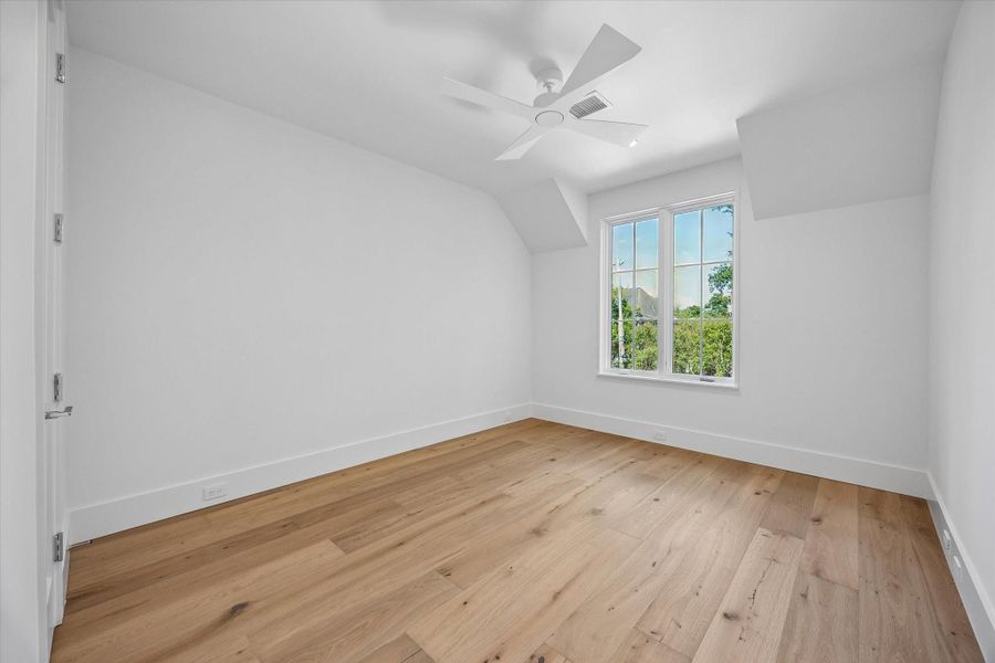 Bedroom Two with white oak hardwood flooring , walk-in closet and ceiling fan Bedroom Two with white oak hardwood flooring , walk-in closet and ceiling fan