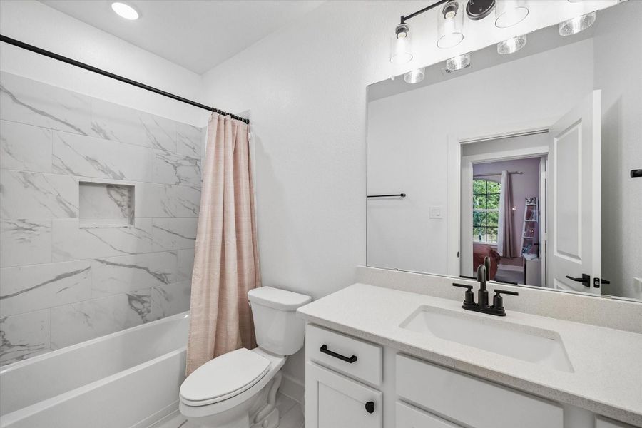 Beautiful secondary bathroom offering modern finishes, quartz countertops, and a bright, polished aesthetic. Beautiful secondary bathroom offering modern finishes, quartz countertops, and a bright, polished aesthetic.