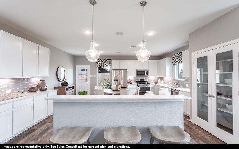 Kitchen featuring white cabinets, french doors, decorative backsplash, a kitchen island, and pendant lighting