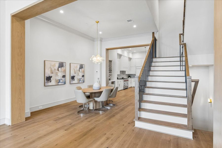 The white oak-wrapped casement creates a dramatic division between the dining room and family room on the second floor. Large open rooms and high ceilings give this home a feeling that is both decadent and welcoming at the same time.